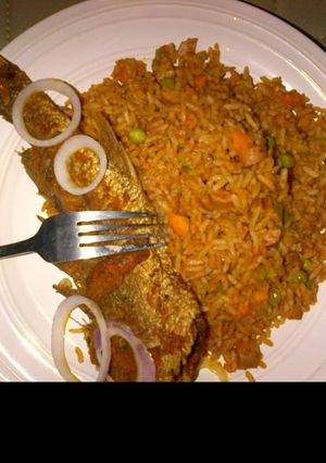 A picture of Jollof rice and fried fish.