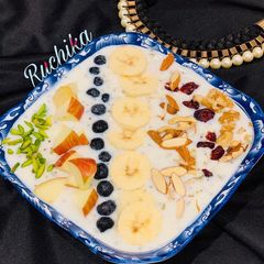 A picture of Oats porridge with fruits nuts.