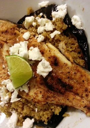 A picture of Pan seared trout served on quinoa chorizo eggplant and French feta salad.