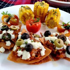 A picture of Nachos With Tomato Salsa & Corn on Cob.