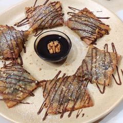A picture of Walnut Pockets with Chocolate Sauce.