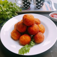 A picture of Corn cheese stuffed flattened rice balls.