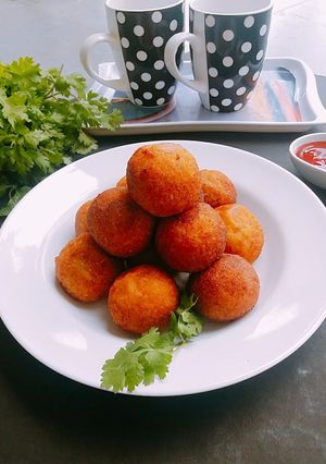 A picture of Corn cheese stuffed flattened rice balls.