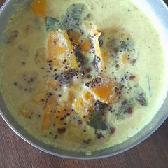 A picture of Mathan pachadi (yellow pumpkin in tamarind coconut gravy).