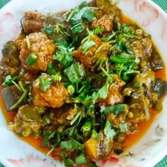 A picture of Baigun bodi(brinjal in dried lentil dumplings).