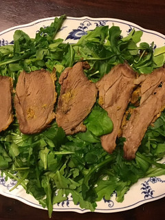 A picture of California Farm Crusted Lamb on Arugula.