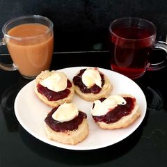 A picture of My Afternoon Tea open Scones with Cherry Jam and Clotted Cream.