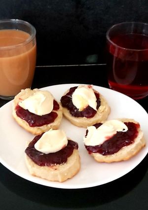 A picture of My Afternoon Tea open Scones with Cherry Jam and Clotted Cream.