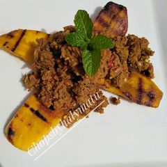 A picture of Beef corn carne on grilled plantain.