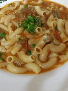 A picture of Pasta in meat and tomato sauce.