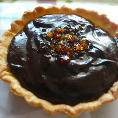 A picture of Bittersweet Chocolate pudding and praline tartlets.