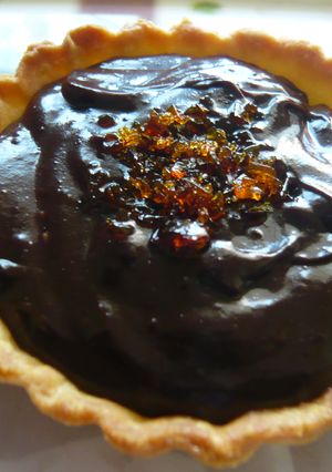 A picture of Bittersweet Chocolate pudding and praline tartlets.