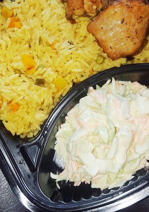 A picture of Fried rice,coleslaw and chicken.