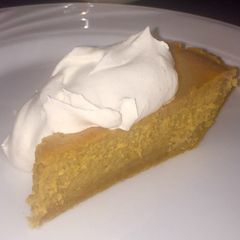 A picture of Pumpkin Cheesecake with Spiced Whipped Cream.
