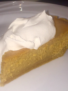 A picture of Pumpkin Cheesecake with Spiced Whipped Cream.