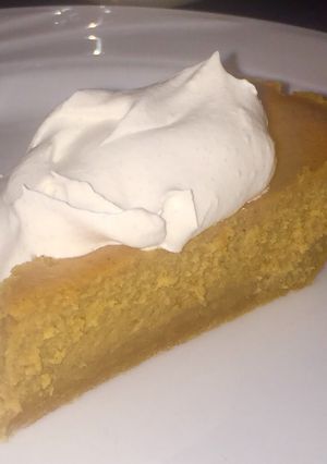 A picture of Pumpkin Cheesecake with Spiced Whipped Cream.