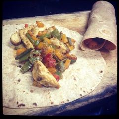 A picture of Healthy chicken and bell pepper burrito.