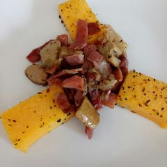 A picture of Speck and porcini with grilled polenta.