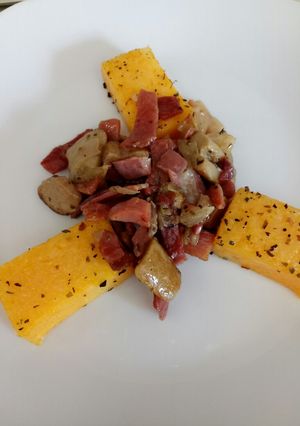 A picture of Speck and porcini with grilled polenta.