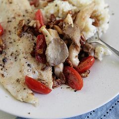 A picture of North Carolina Trout with Sautéed Oyster Mushrooms and Pecans with Gouda Grits.