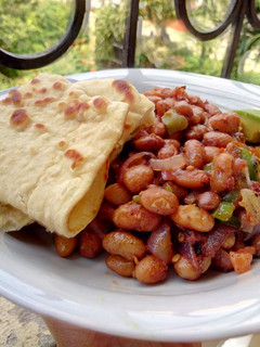 A picture of Coconut cumin beans with Naan bread.