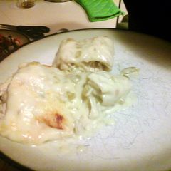 A picture of white chicken enchiladas.