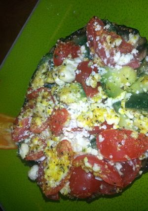 A picture of zucchini tomato feta stuffed portabella.