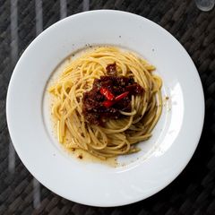 A picture of Oil pasta with dried tomatoes and anchovies.