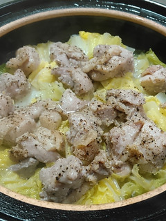 A picture of Steamed Chicken Thighs with Garlic and Black Pepper on Napa Cabbage.