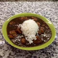 A picture of Abigaile's Étouffée served with rice.