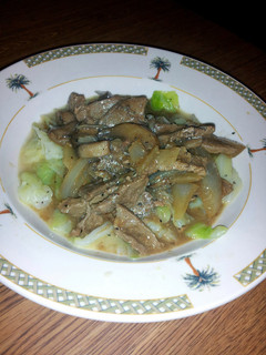 A picture of smothered thin steak over cabbage.