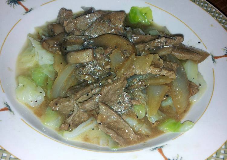 smothered thin steak over cabbage
