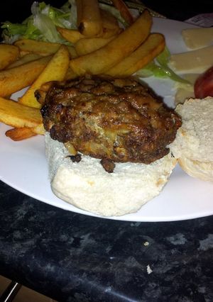 A picture of grilled white onion beef burgers.