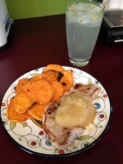 A picture of Pork Steak With Apple Sauce And Kumara Chips.