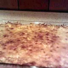 A picture of loads of cheese baked mac n cheese.