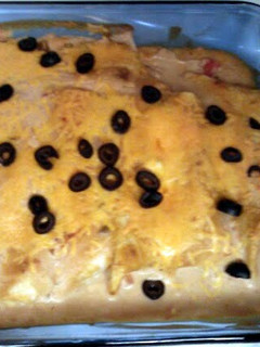 A picture of Turkey enchiladas w/ creamy sauce.