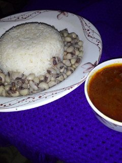 A picture of Rice and Beans with stew.