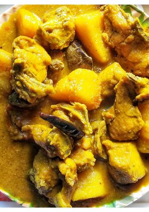 A picture of Bengali style potato chicken curry.