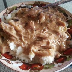 A picture of Chicken and gravy over mashed potatoes.