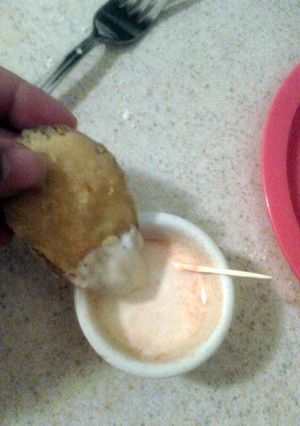 A picture of Fried pickles with dipping sauce.