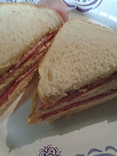 A picture of Ham and smoked salmon cream cheese sandwich.