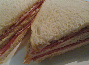 A picture of Ham and smoked salmon cream cheese sandwich.