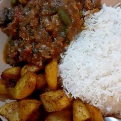 A picture of Beef stew/white rice/spicy garlic potatoes.