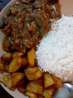 A picture of Beef stew/white rice/spicy garlic potatoes.