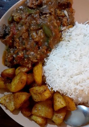 A picture of Beef stew/white rice/spicy garlic potatoes.