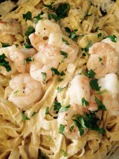 A picture of Creamy Pasta Alfredo With Shrimp Scampi.