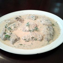 A picture of Pork Medallions in a Mustard Apple Brandy Green Peppercorn Sauce.