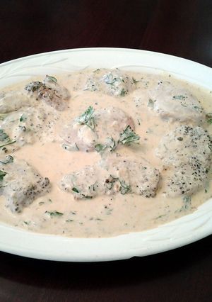 A picture of Pork Medallions in a Mustard Apple Brandy Green Peppercorn Sauce.