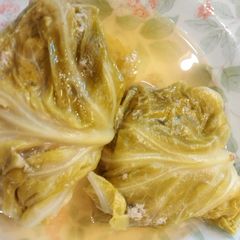 A picture of Ground meat rolled in cabbage leaves.