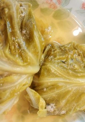 A picture of Ground meat rolled in cabbage leaves.